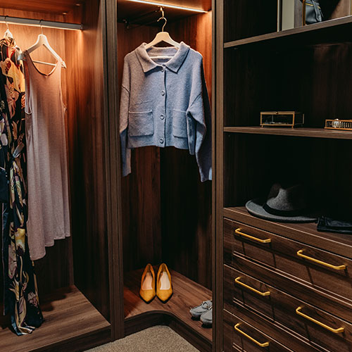 Bespoke walk in wardrobe with clothes hanging